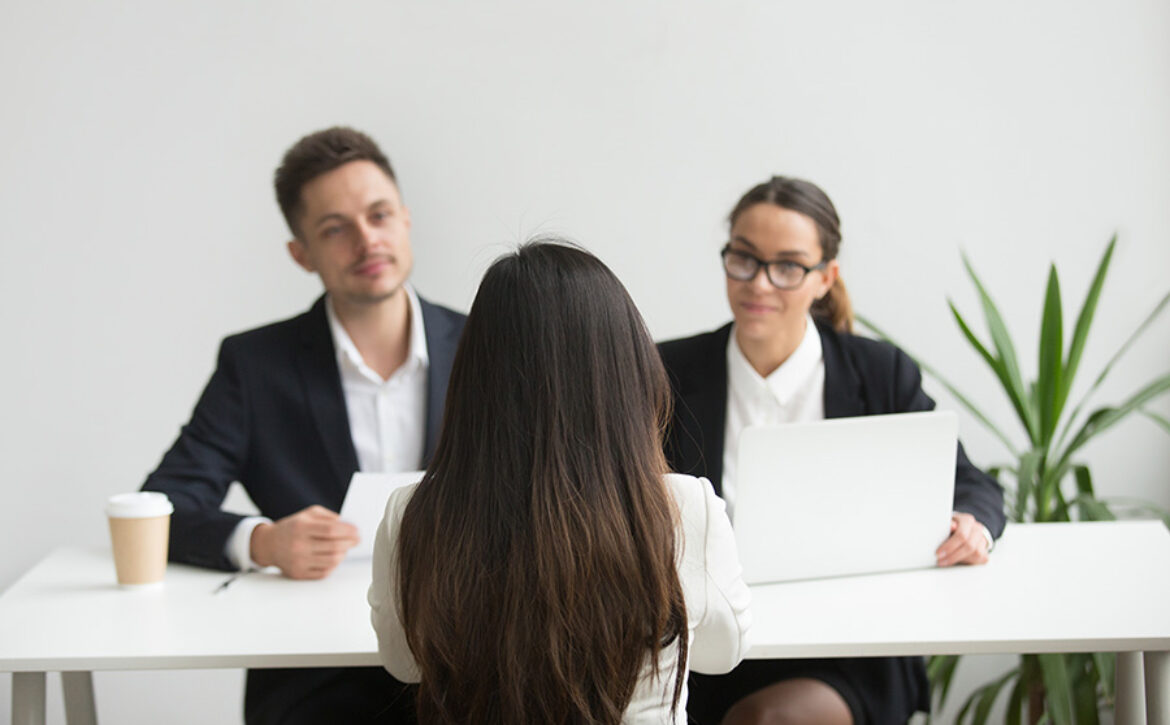 Headhunters interviewing female job candidate