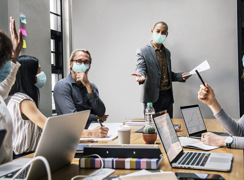 Business people wearing masks in coronavirus meeting, the new no