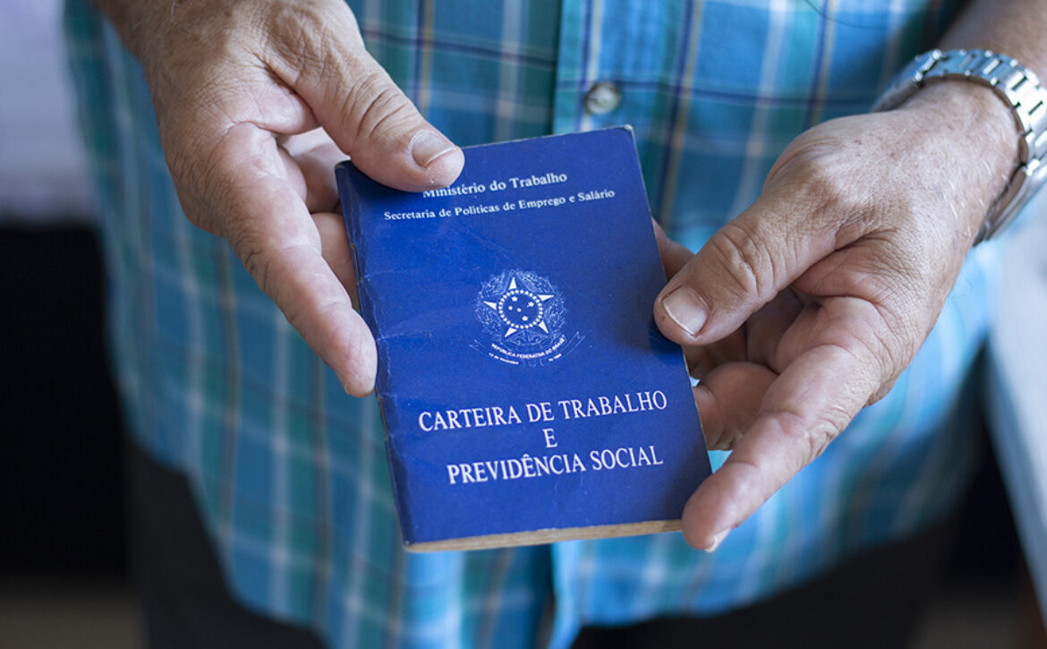Man holding Brazilian work card. Selective focus.