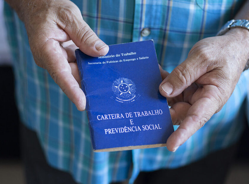 Man holding Brazilian work card. Selective focus.
