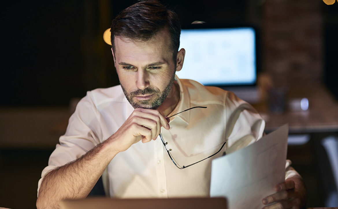 Focused man working late in his home office