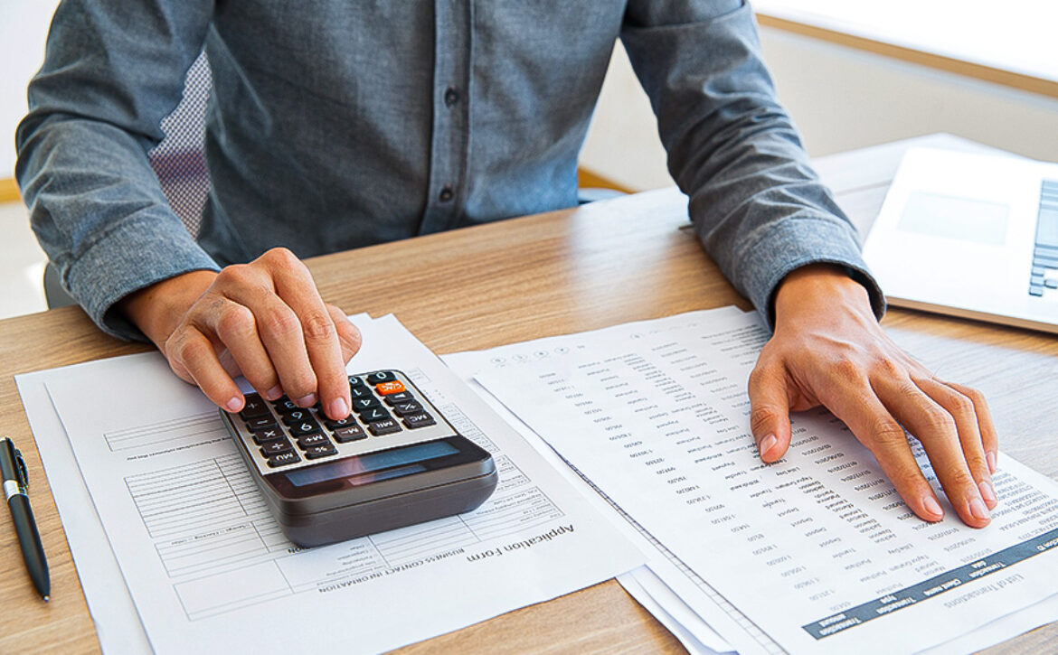 Accountant calculating income and examining report