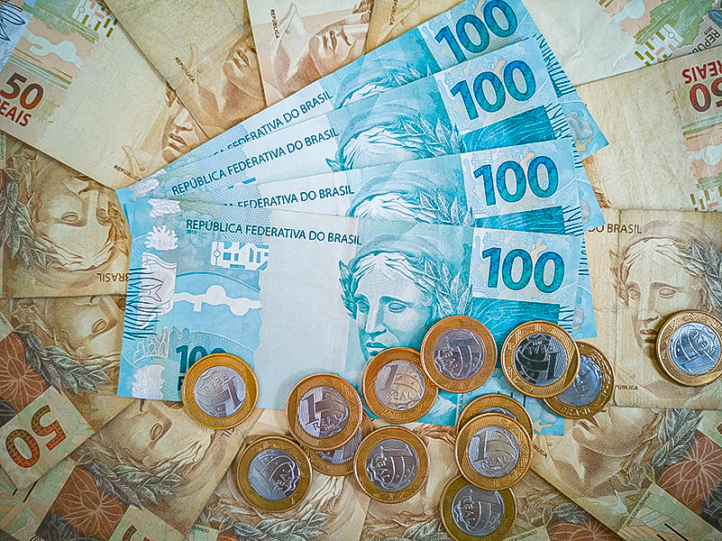 Brazilian money. Coins and money bills of different values stack